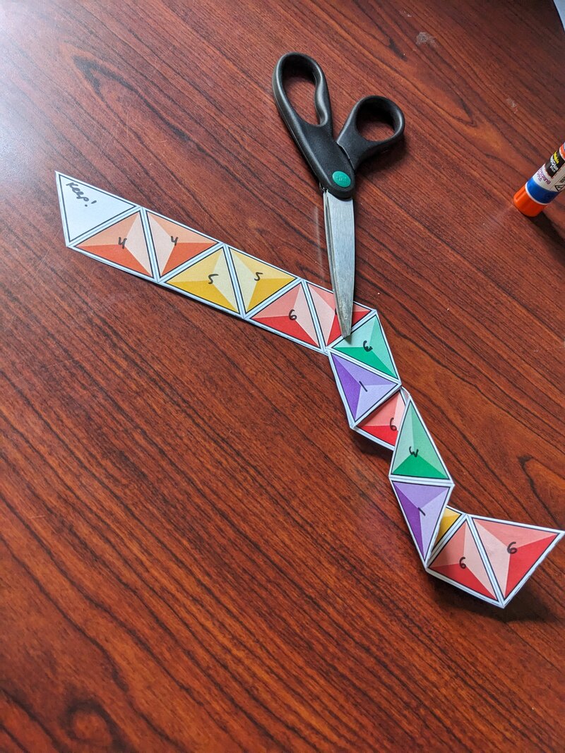 A partially folded strip that has begun to coil